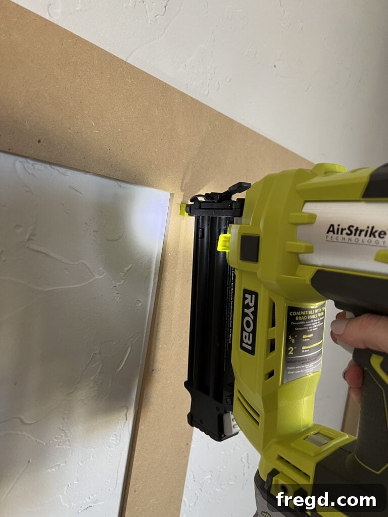 Transform Your Home with DIY Board and Batten Paneling 6 Preparing and measuring for the installation of the horizontal bender boards.