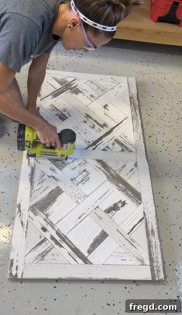 Triangle-shaped wood pieces being precisely cut and fitted to finish the intricate parquet pattern on the DIY coffee table.