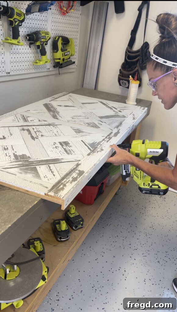Long trim pieces being attached flush with the parquet table top, creating a clean finished edge.