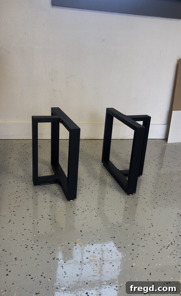 A close-up view of the black metal table legs securely attached to the underside of the coffee table top.