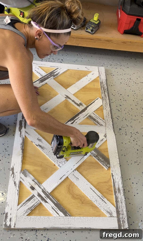 Long diagonal pieces of barn wood being measured, cut, and fitted into the evolving parquet pattern on the coffee table top.