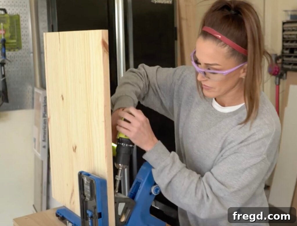 Craft Your Own Vinyl Listening Station 3 Close-up of a Kreg Jig 720PRO in use, drilling pocket holes into wood