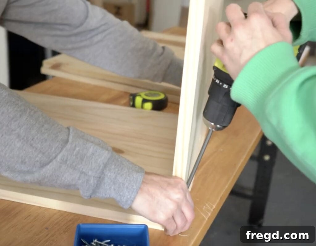 Craft Your Own Vinyl Listening Station 4 Attaching a shelf board to the side panel of the record player stand using pocket hole screws