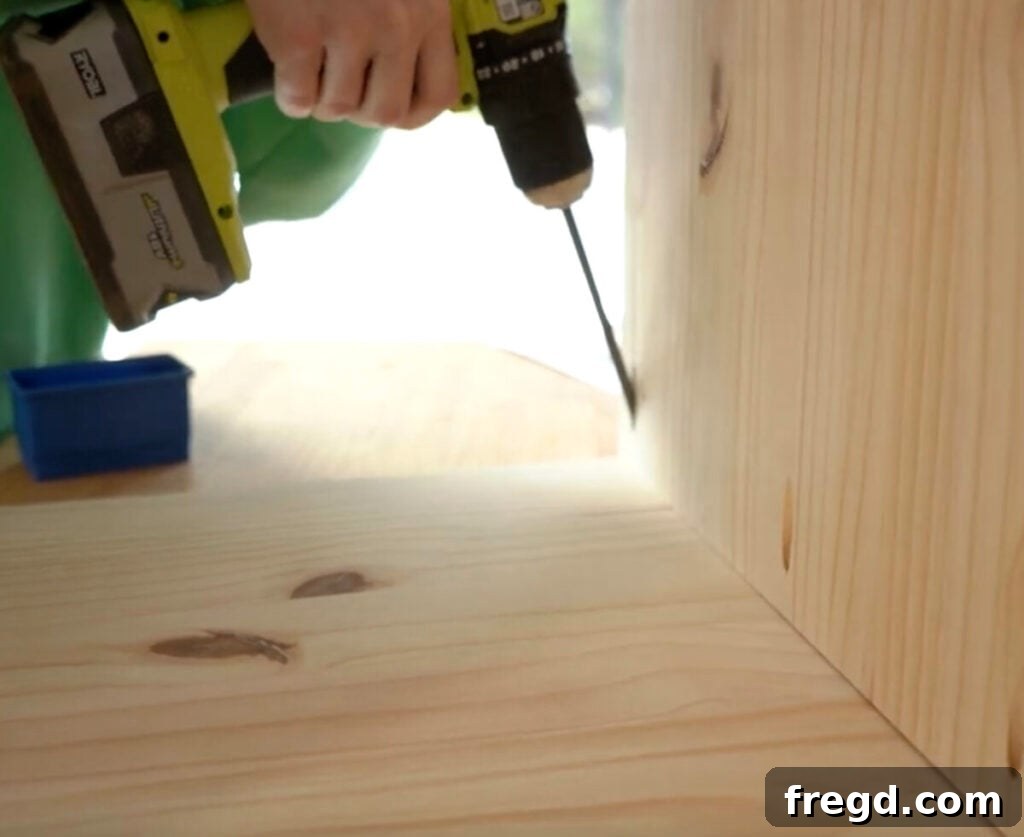 Craft Your Own Vinyl Listening Station 5 Close-up view of pocket hole screws securing a wooden shelf to a side panel