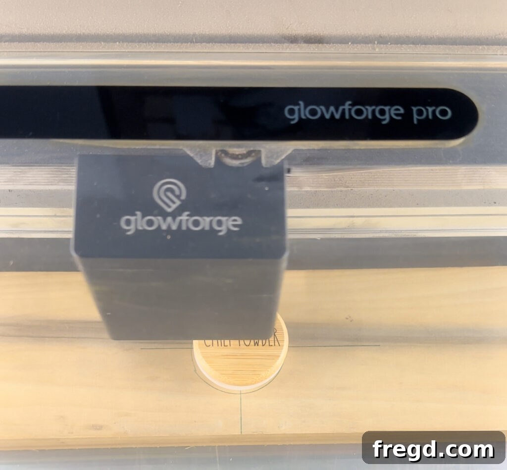Craft Your Custom Countertop Spice Organizer 17 Spice jars with bamboo lids being engraved with a Glowforge laser cutter.
