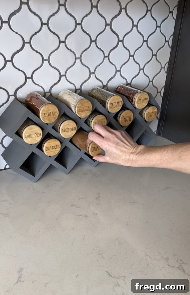 Craft Your Custom Countertop Spice Organizer 19 Placing filled and labeled spice jars into the completed spice rack.