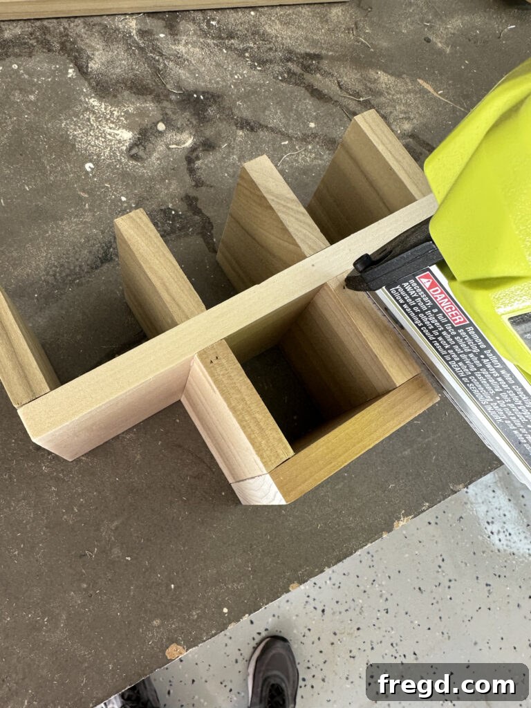 Craft Your Custom Countertop Spice Organizer 6 Close-up showing nails shot diagonally into the middle divider pieces.