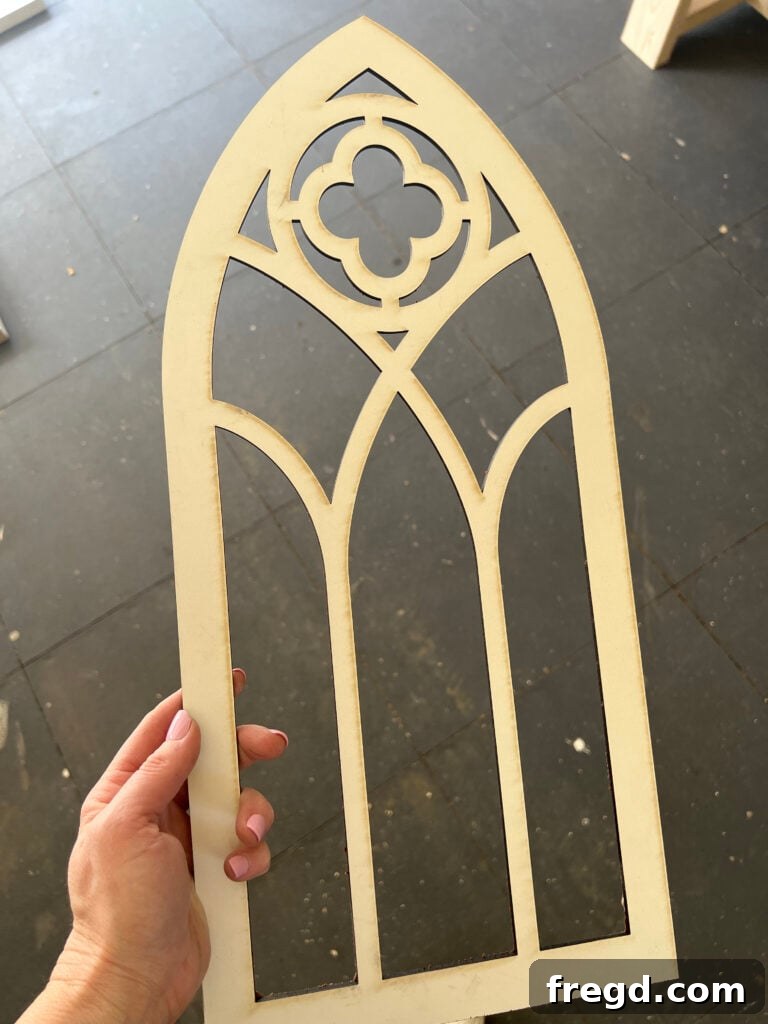 Build Your Own Elegant Buffet Table 18 A finished cabinet door with a laser-cut arched panel meticulously attached to its center, showcasing a modern farmhouse aesthetic.