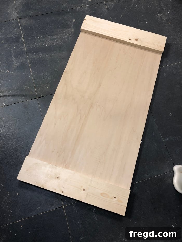 Build Your Own Elegant Buffet Table 8 An overhead view showcasing the completed construction of a cabinet side panel, highlighting the clean lines and flush surfaces created by the plywood and trim.