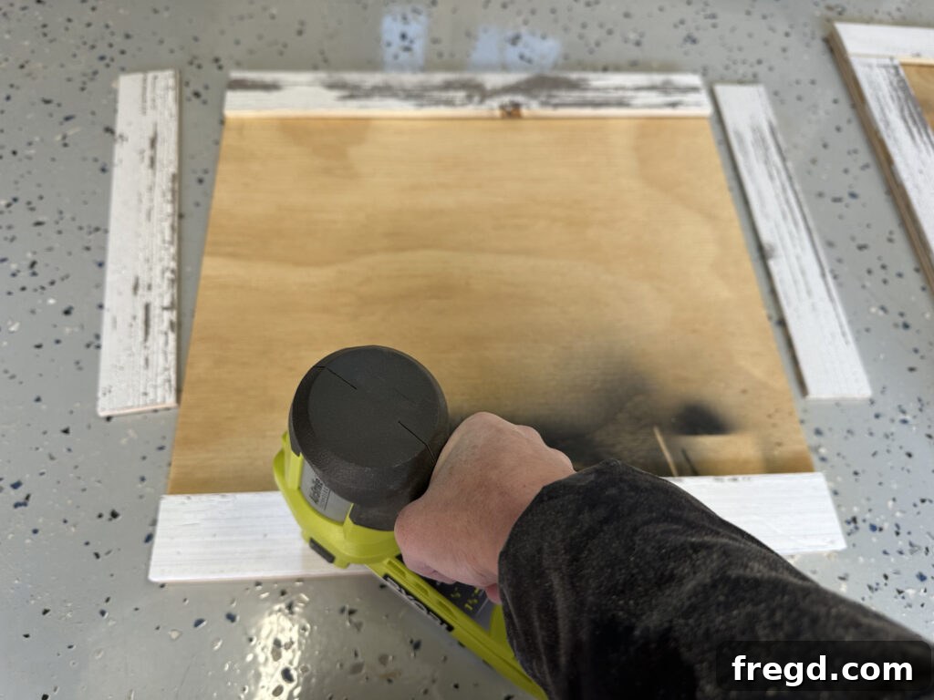 Your First End Table A Simple DIY Project 4 Short frame pieces being attached to the plywood with pin nails and wood glue