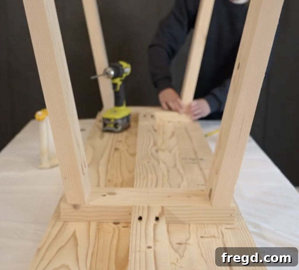 Close-up view of an angled bench leg being secured with pocket hole screws.