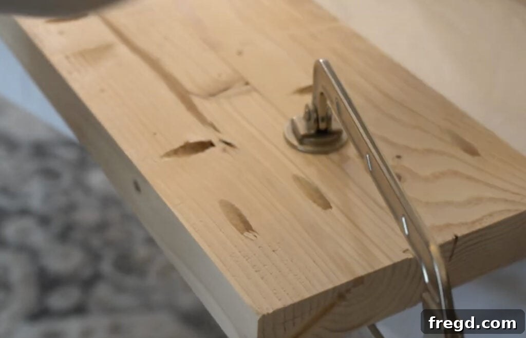 Using Kreg Face Clamps to hold wooden planks flush during assembly of the bench top.