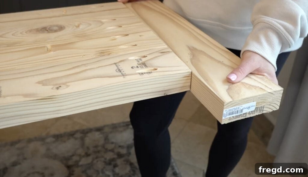 Attaching a breadboard to the end of the bench top planks.