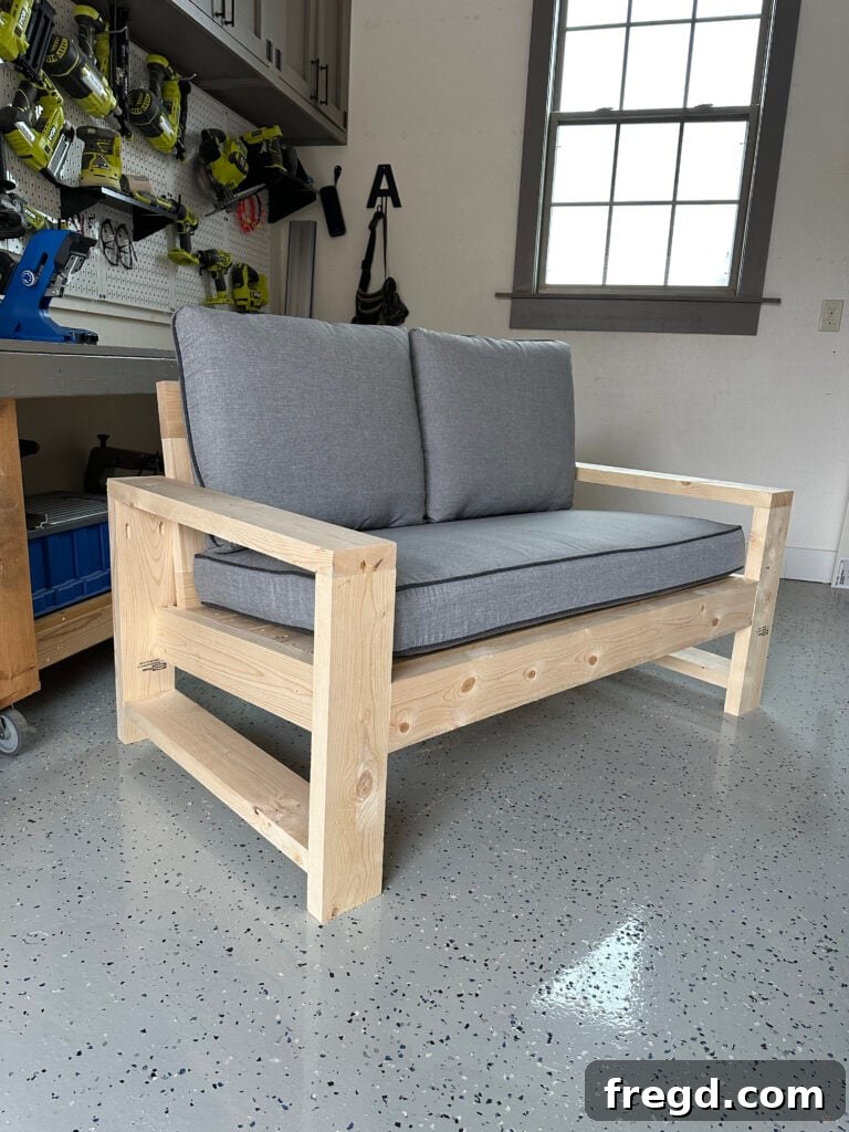 Testing outdoor cushions on the newly built DIY couch to ensure a perfect fit