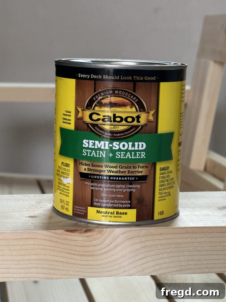 Applying outdoor wood stain to the DIY couch for protection and color