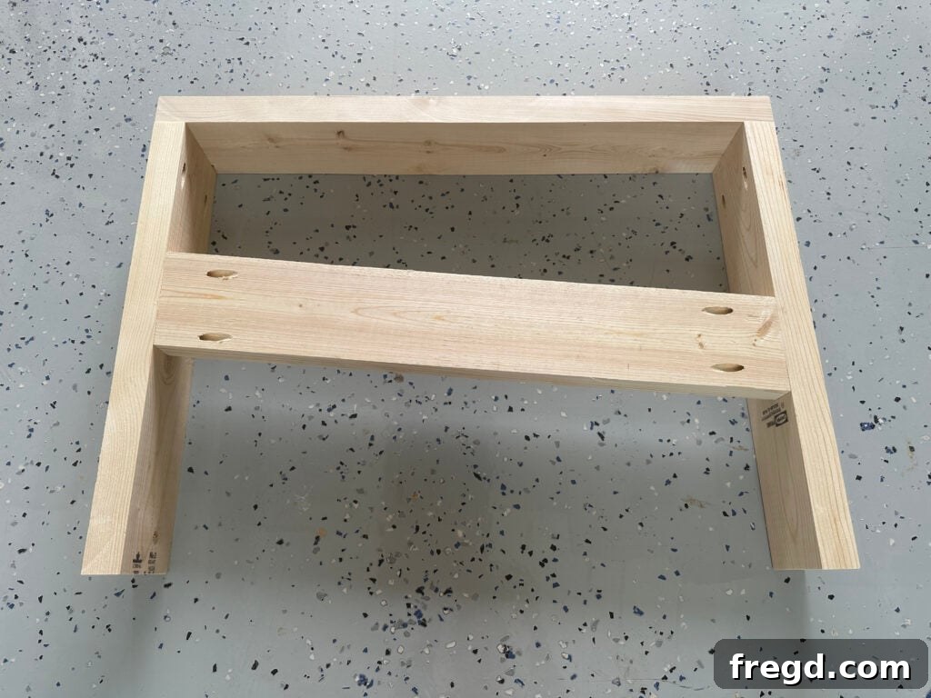 Process of attaching the side runner with pocket holes between the legs of the arm assembly
