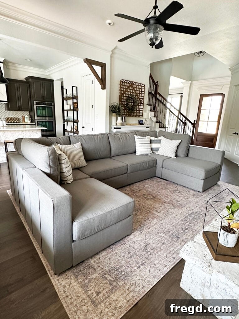 A wide shot of the living room, featuring the Lovesac Sactional as the focal point, surrounded by tasteful decor.