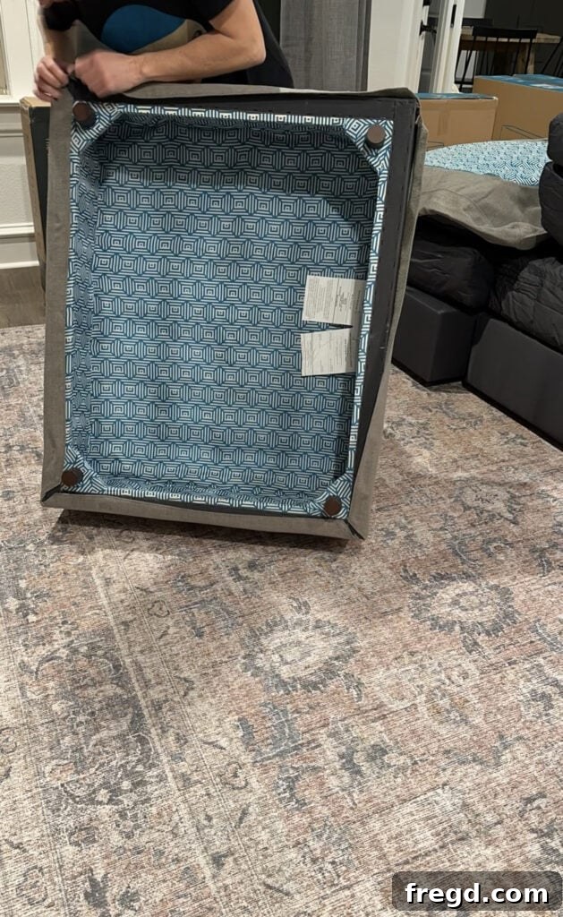 A Lovesac Sactional base piece being covered with its fabric cover, showing the snug fit and quality material.