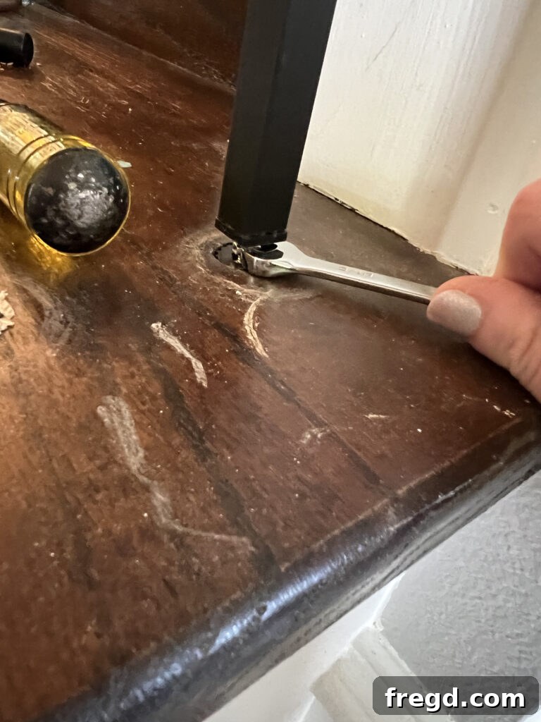 DIYer tightening a new baluster into place using the Tap N' Twist system.