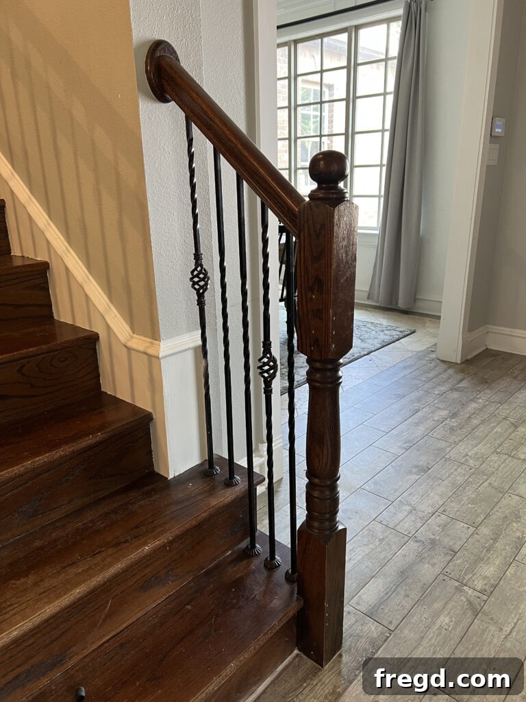 Before shot of the old, slender newel post on the staircase.