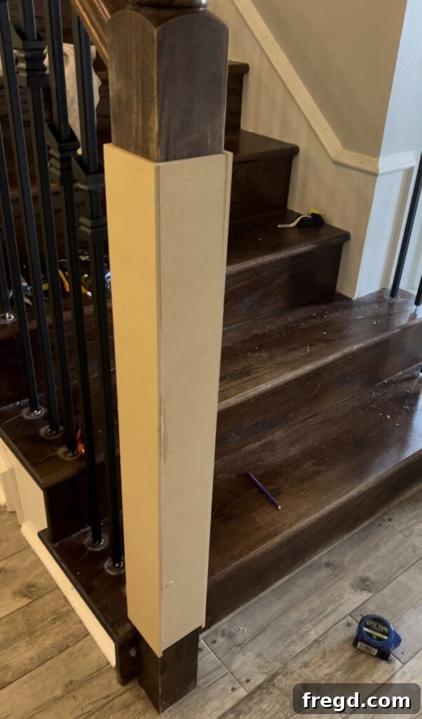 Wrapping the base of the existing newel post with 1/4-inch MDF panels.