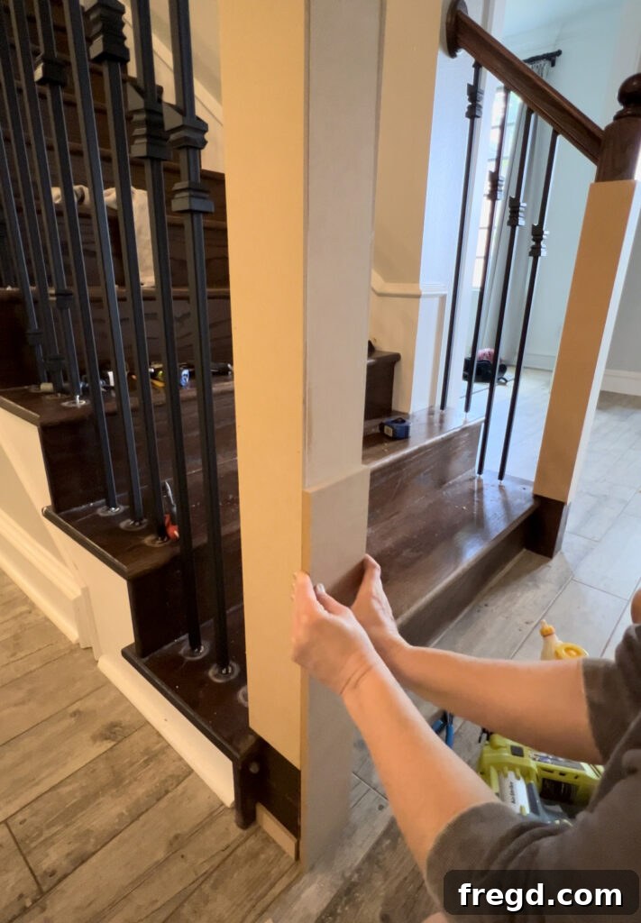 Building up the newel post with 1/2-inch MDF, extending about 24 inches from the base.