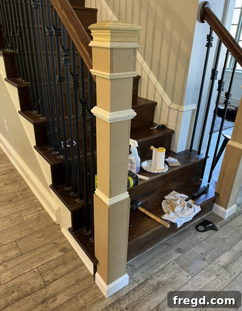 The newly built-up newel post with a decorative post cap installed, awaiting finish.