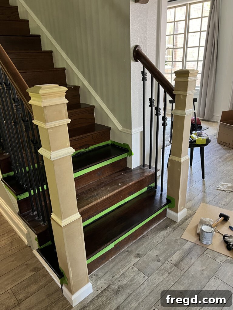 Stair treads taped off with Frog Tape, showing the careful preparation for staining.