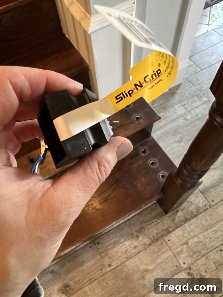 Close-up of black flat shoes designed for securing balusters to flat surfaces.