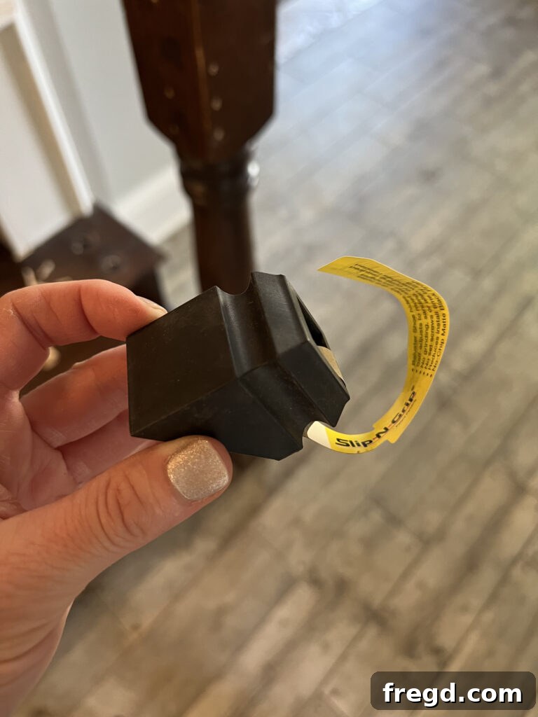 Close-up of black angled shoes for baluster connections to sloped handrails.