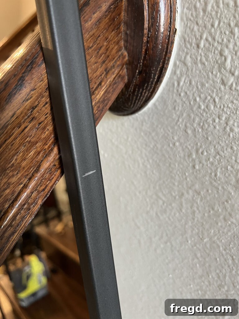 DIYer using a jigsaw with a metal cutting blade to precisely trim a baluster to length.