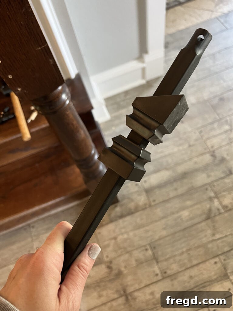 Close-up of a baluster with flat and angled shoes slid onto it, ready for installation.