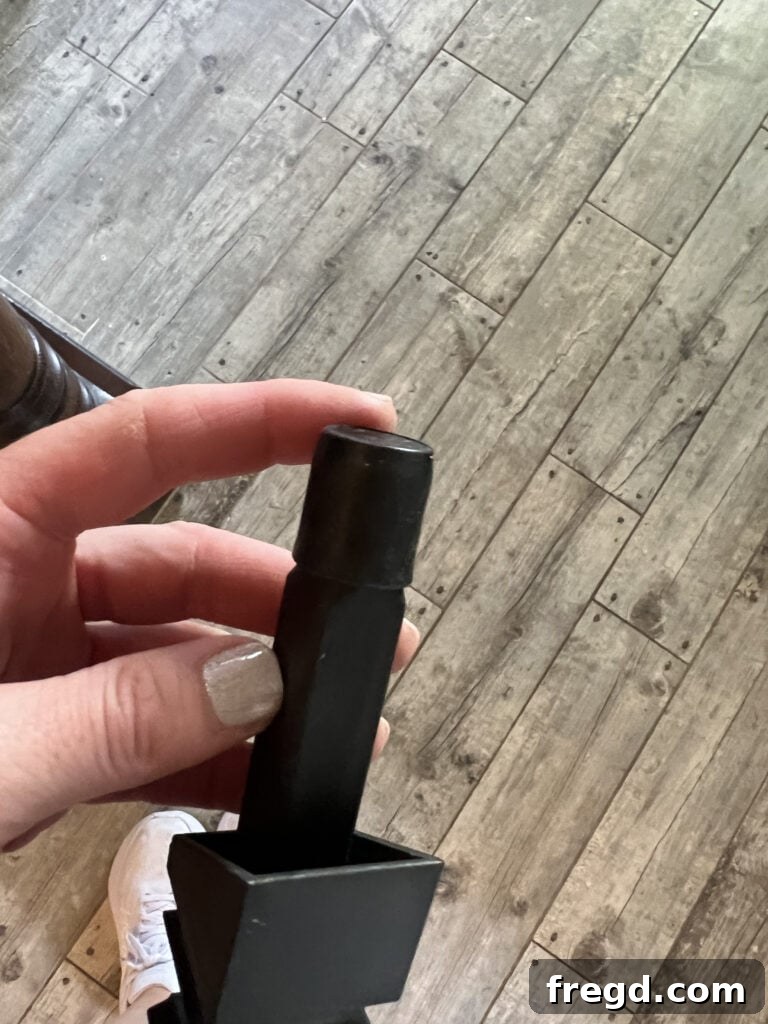 Demonstration of attaching the rubber cap to the top of the metal baluster.