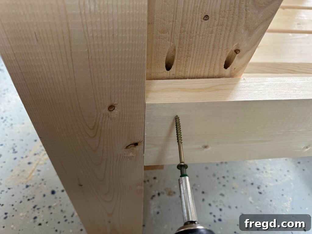 Attaching the completed backrest assembly to the main chair frame, aligning with the cleats.