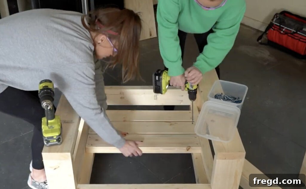 Using a Kreg Quick Flip tool to drill pilot holes for seat slats on the outdoor chair.