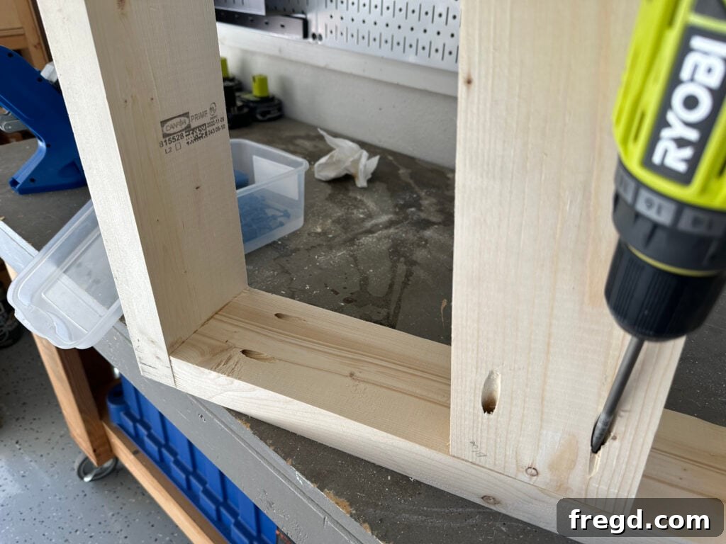 Attaching the side seat supports to the arm frames of the outdoor chair using pocket holes.
