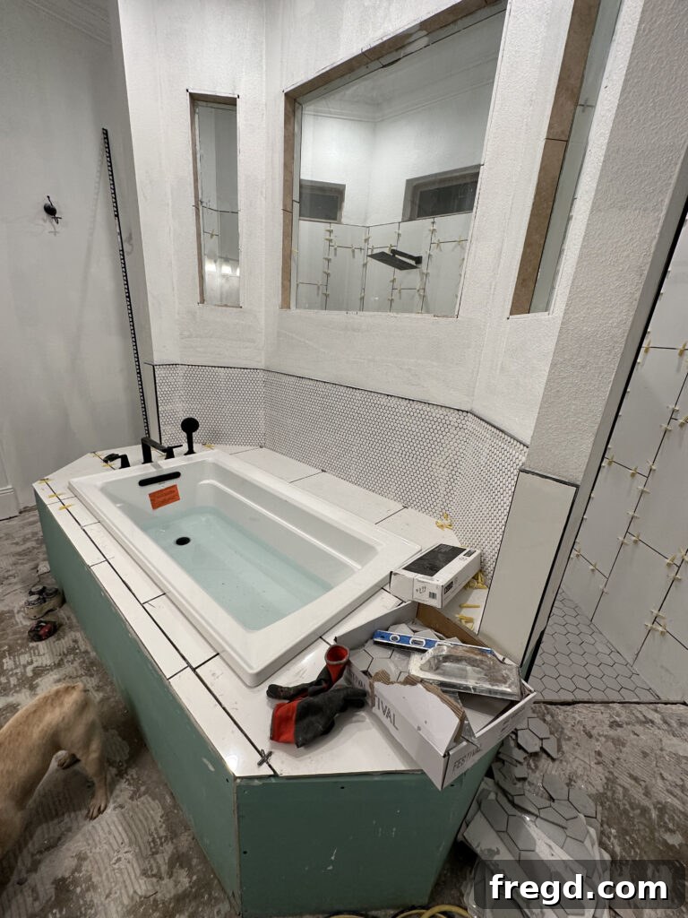 Master Bath Oasis Reimagined 18 Bathtub deck with large subway tiles and penny tile backsplash.