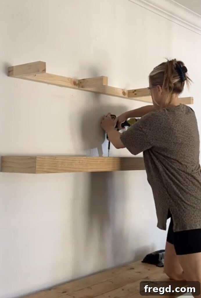 Modern Dining Room Makeover DIY Floating Shelves 11 Close-up of securing the floating shelf box to the internal cleat