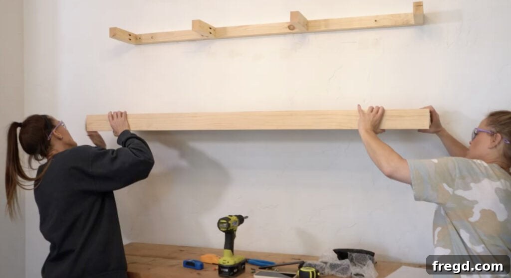 Modern Dining Room Makeover DIY Floating Shelves 10 Attaching the stained shelf box over the wall cleat with wood screws