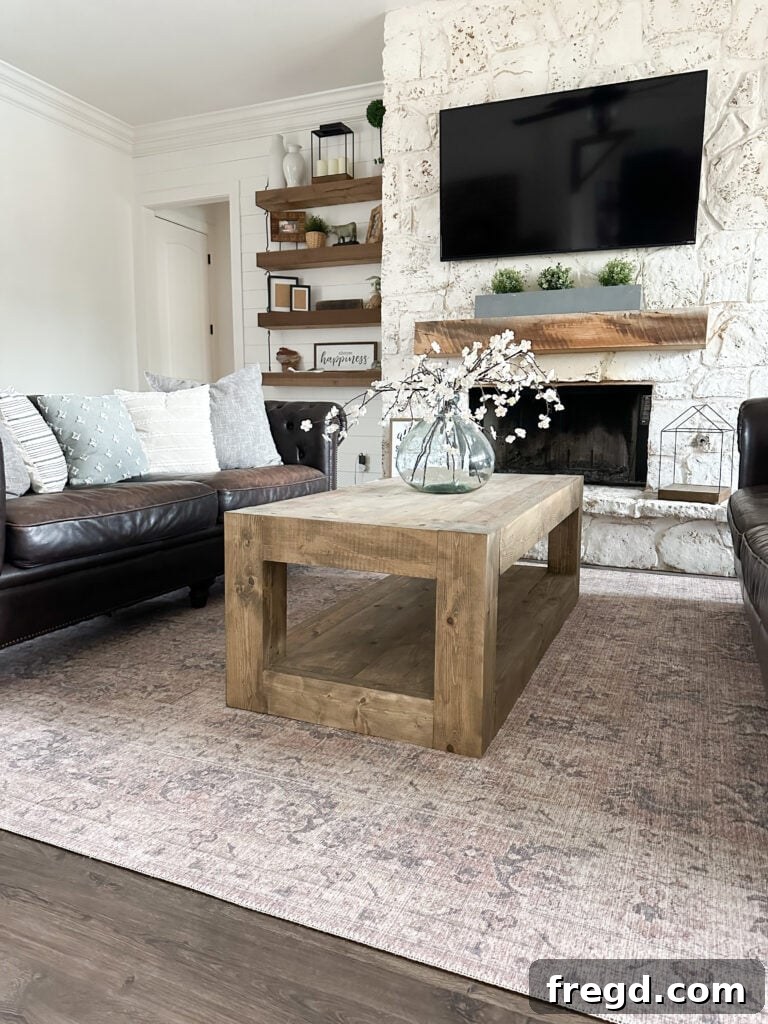 Handcraft a Modern Wood Coffee Table 2 Finished modern wood coffee table with chunky legs and a planked top, adorned with decor.