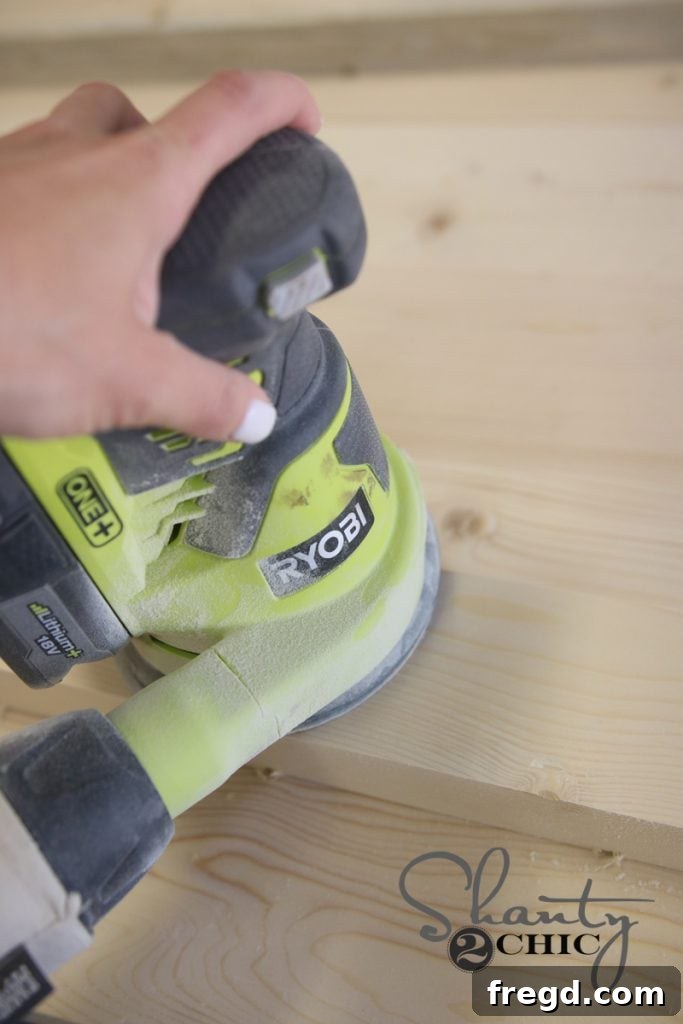 Handcraft a Modern Wood Coffee Table 13 Wood coffee table being sanded with an orbital sander.
