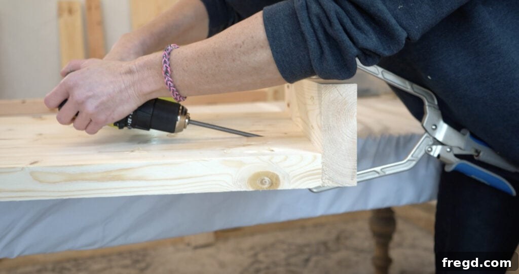 Handcraft a Modern Wood Coffee Table 7 Short apron piece being attached to the plank assemblies with pocket hole screws and wood glue.