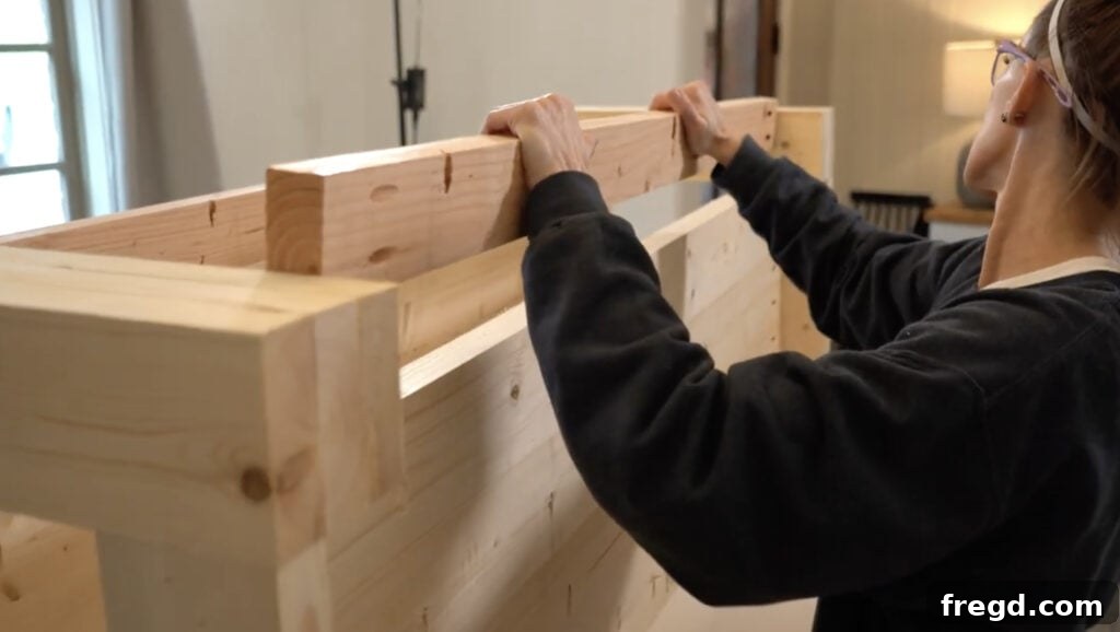 Handcraft a Modern Wood Coffee Table 10 Remaining side planks being attached to the bottom plank assembly with pocket hole screws and wood glue.