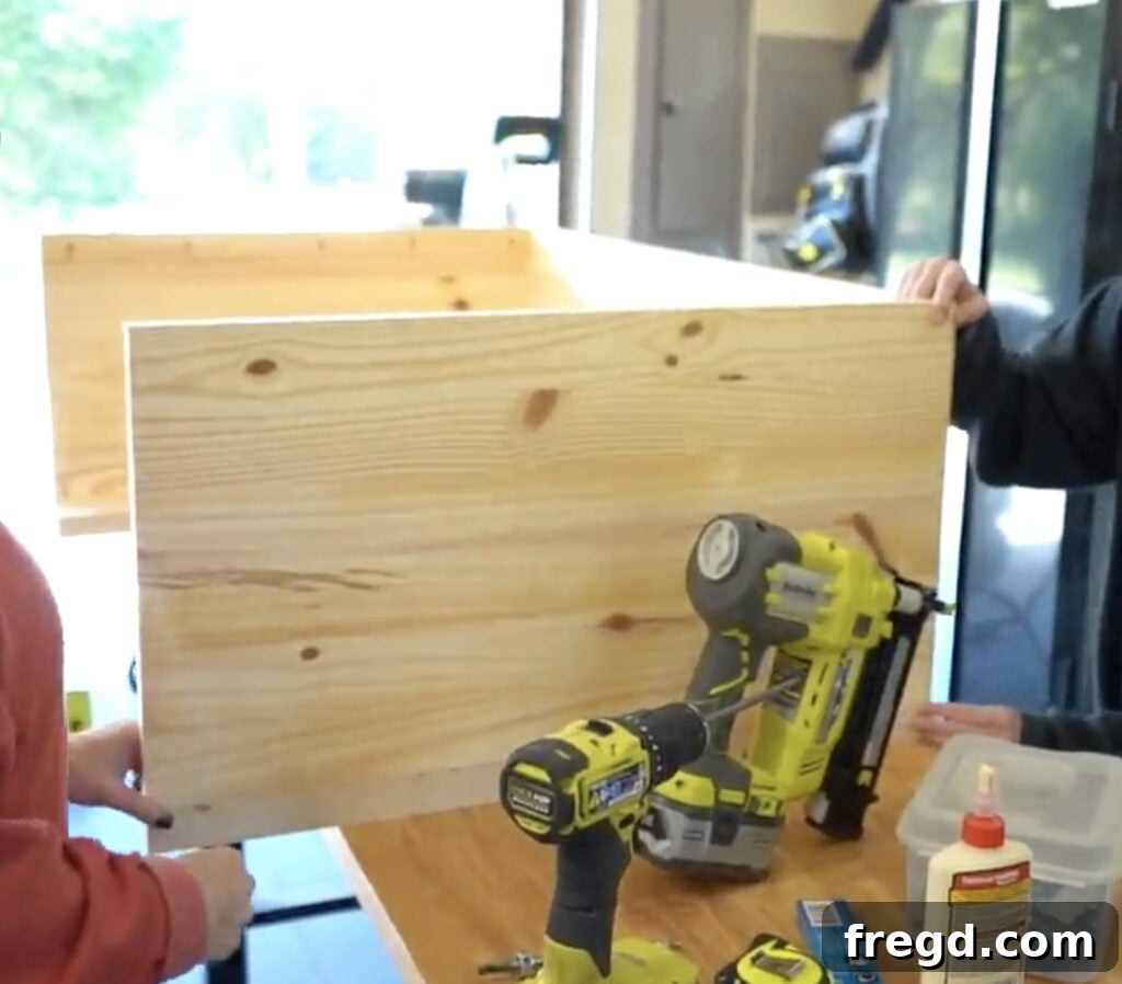 Elegant Waterfall Desk Build 12 Applying wood glue to the frame for the outer side panel