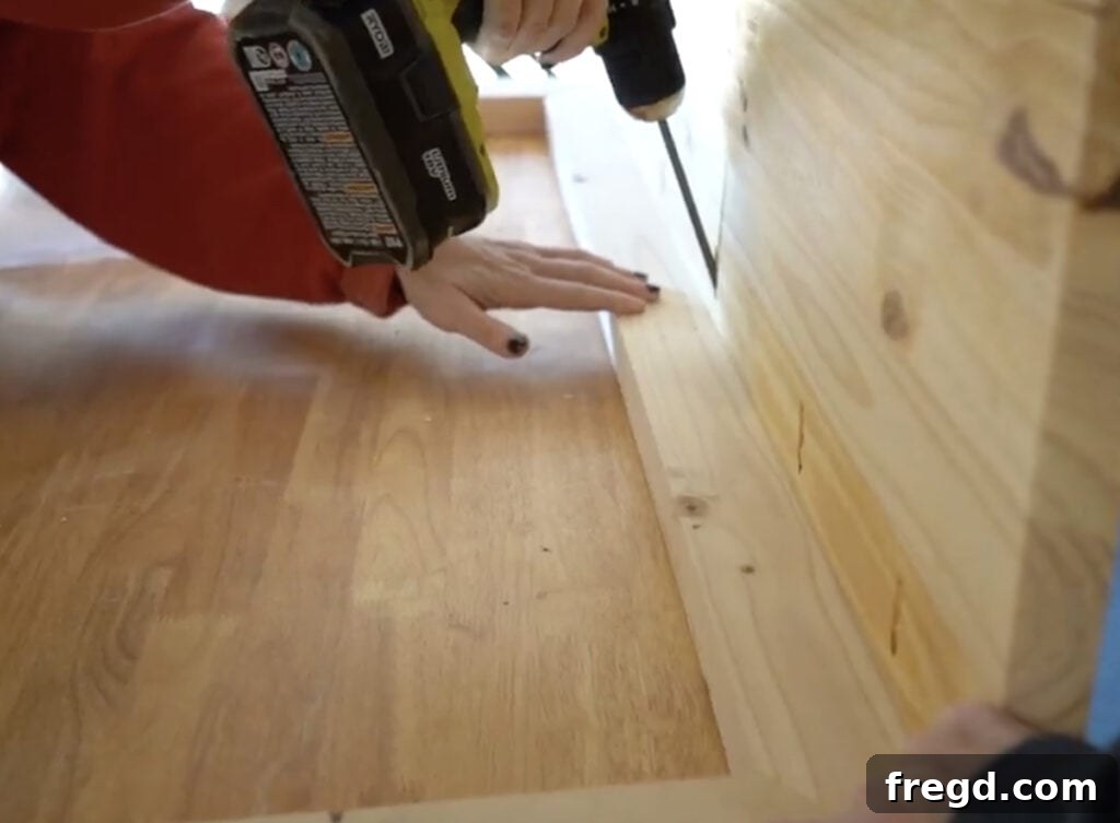 Elegant Waterfall Desk Build 9 Applying wood glue to the top edge of the desk frame