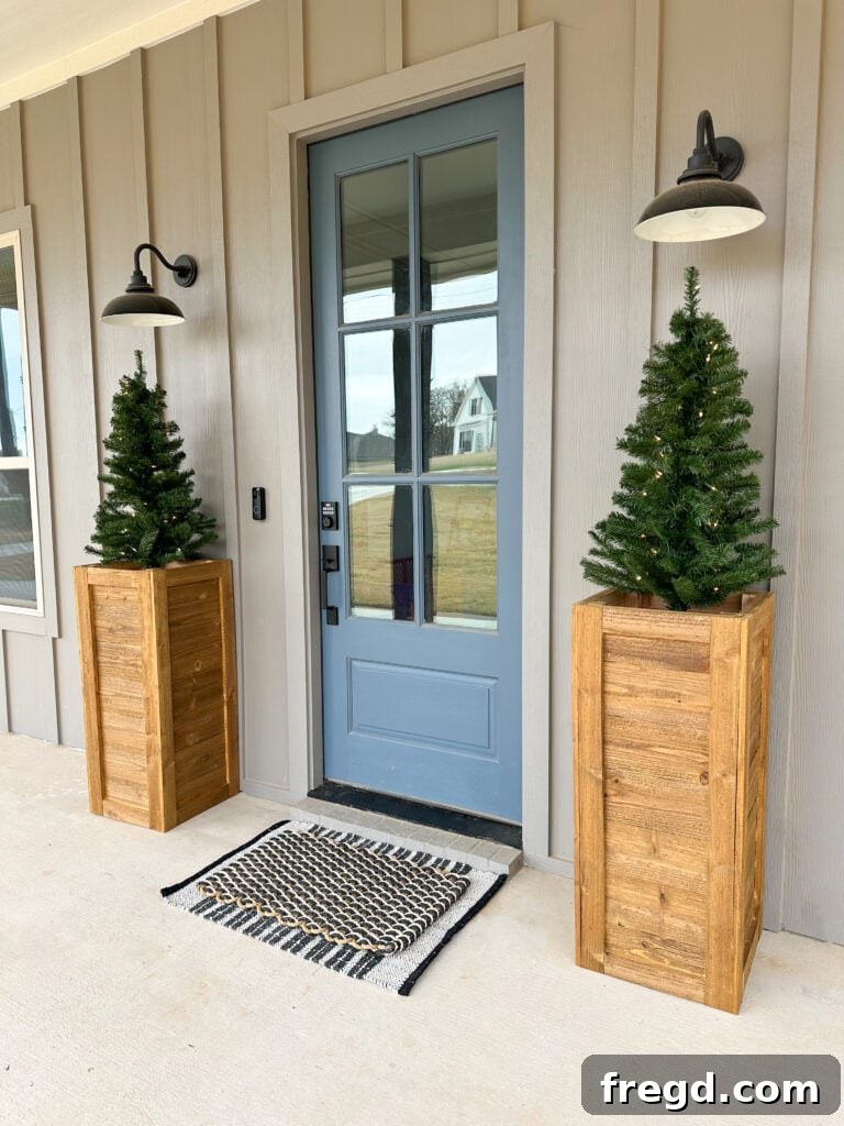 A wider shot of the porch showcasing the cedar columns, windows, and the newly built planter boxes contributing to the overall charm.