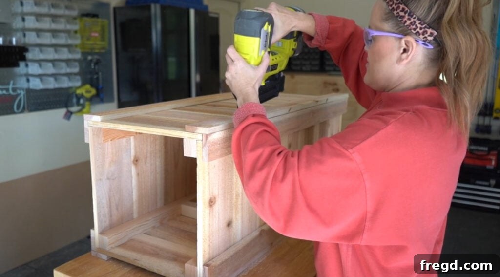Attaching the remaining long trim pieces to the long sides of the planter, overlapping the short trim for a clean corner.