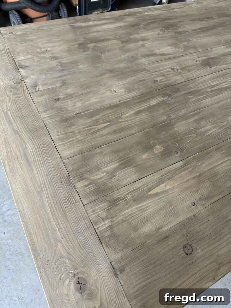 Build Your Own Dining Table with Free DIY Plans 24 Close-up of the two-tone stain finish on the dining table