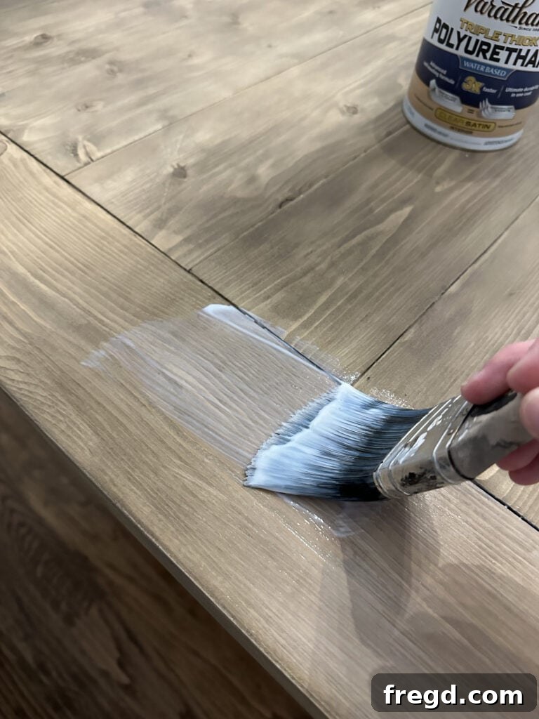 Build Your Own Dining Table with Free DIY Plans 27 First coat of polyurethane applied, appearing white, but will dry clear
