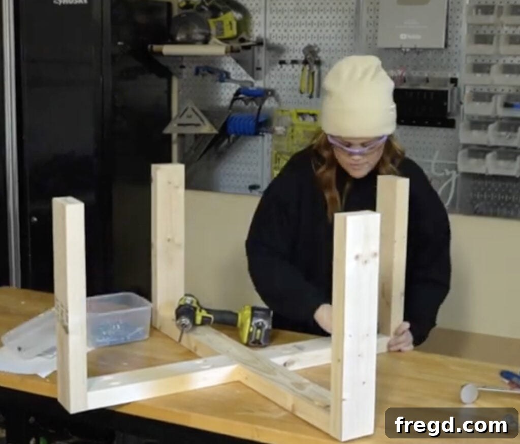 Attaching the second X-shaped component to the coffee table legs